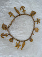 Yves Saint Laurent gold metal belt pendant sea 80s
