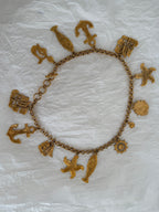 Yves Saint Laurent gold metal belt pendant sea 80s