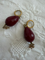 Red earrings pendant with golden four-leaf clover